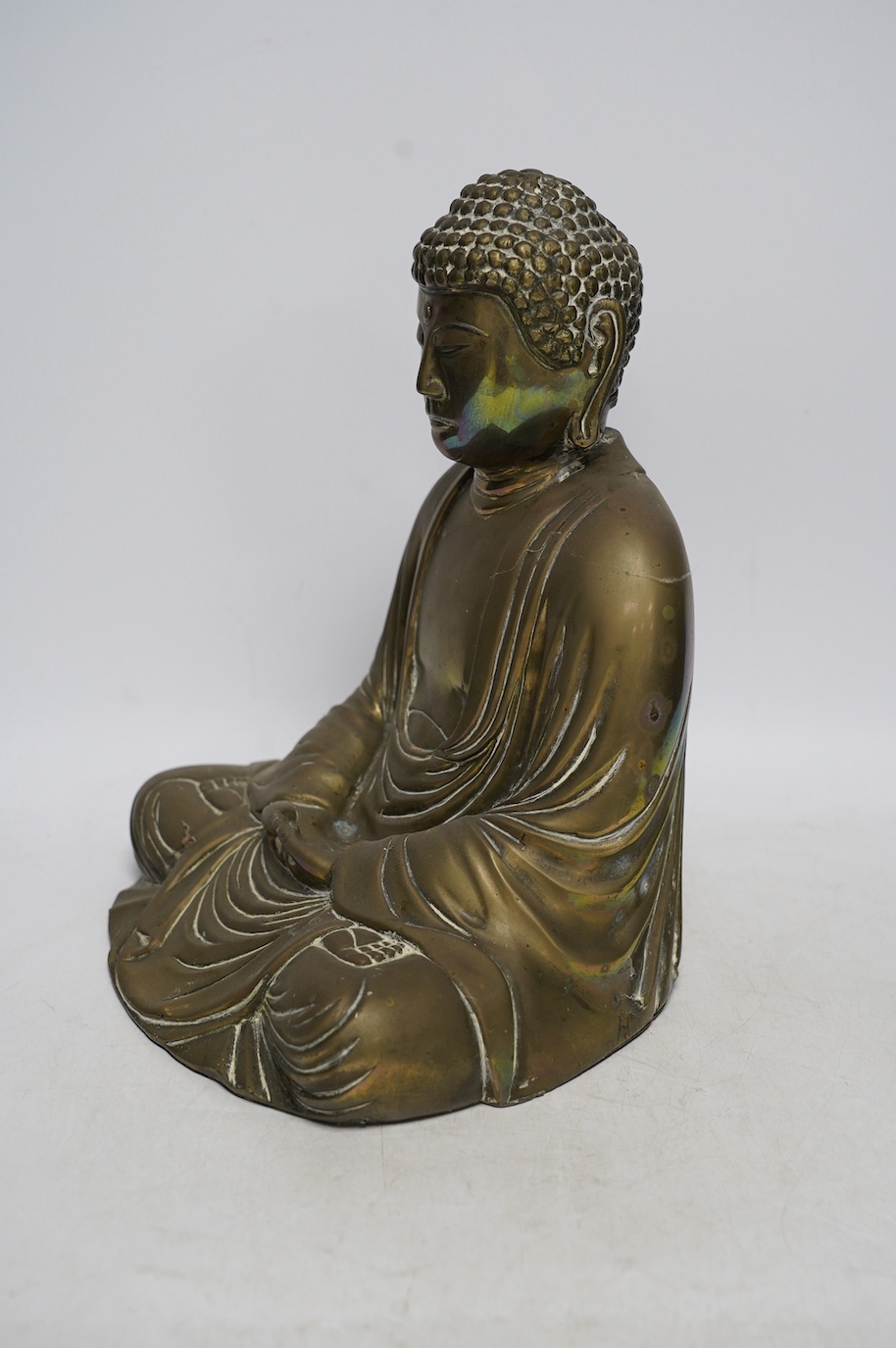 A cast brass figure of Buddha, 27cm high. Condition - fair to good